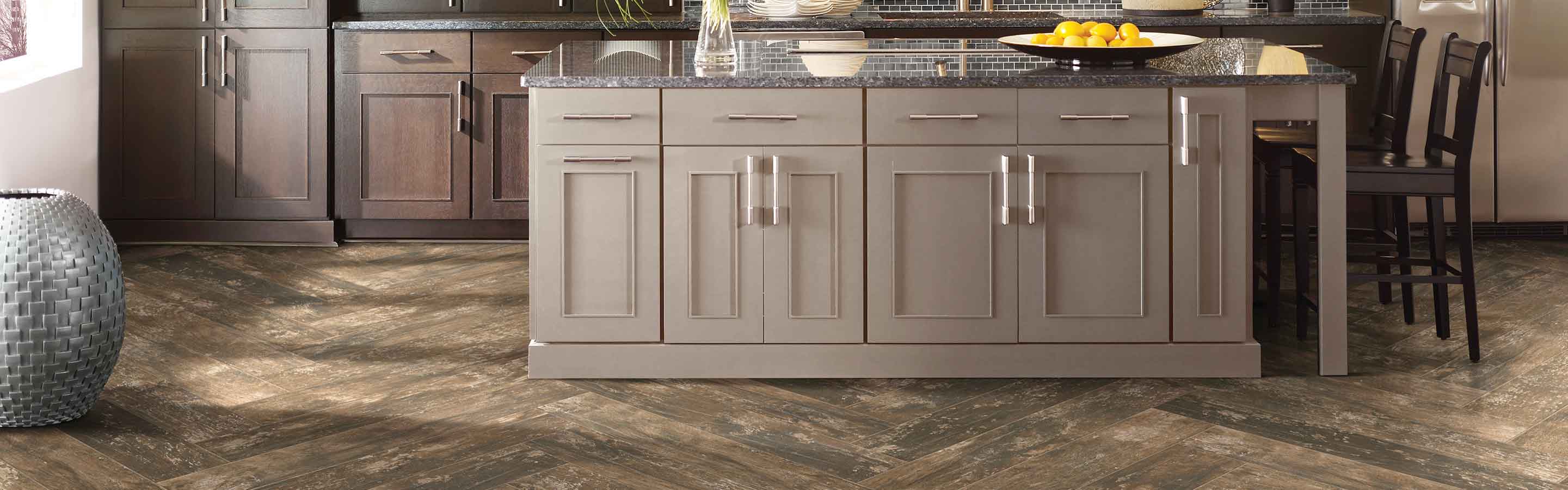 Kitchen brown flooring and cabinets and dark tile table top